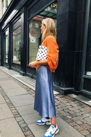 blue slip skirt with orange sweater