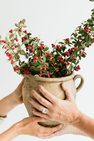 crock with holiday branches