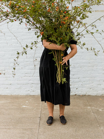 woman holding branches