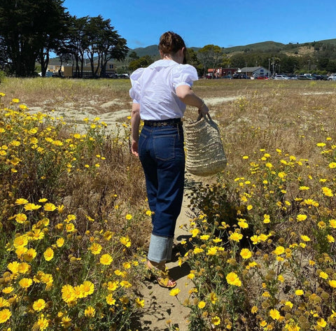 woman in field of yellow flowers