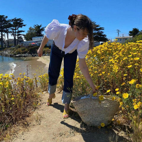 woman in field of yellow flowers