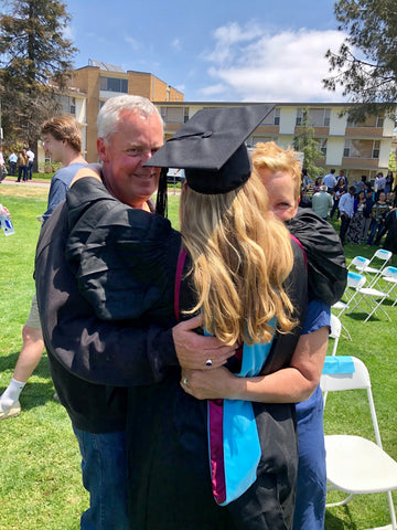 graduate hugging parents