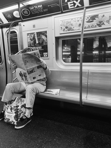 man reading new york times on subway