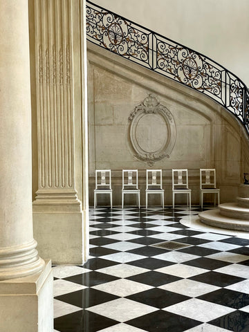 staircase with black and white tiled floor