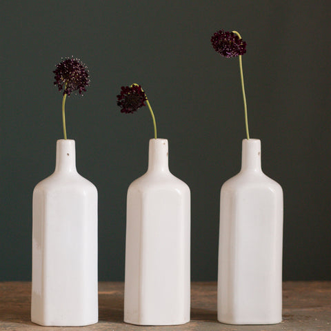 triangular stoneware bottles with flowers