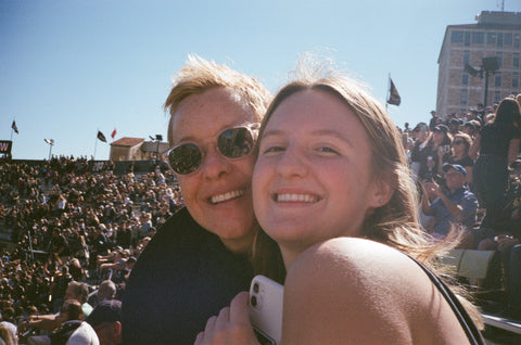 two women smiling at football game