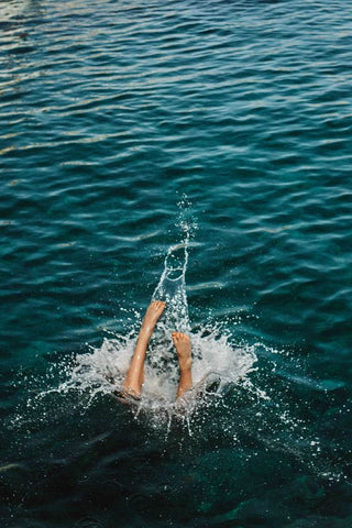 woman diving into ocean