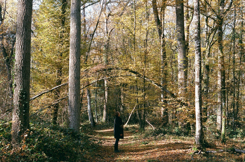 woman walking through forest