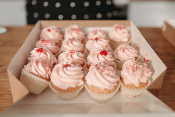 Cherry topped cupcakes in a box
