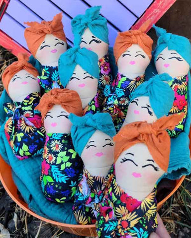 handmade dolls pictured in group basket