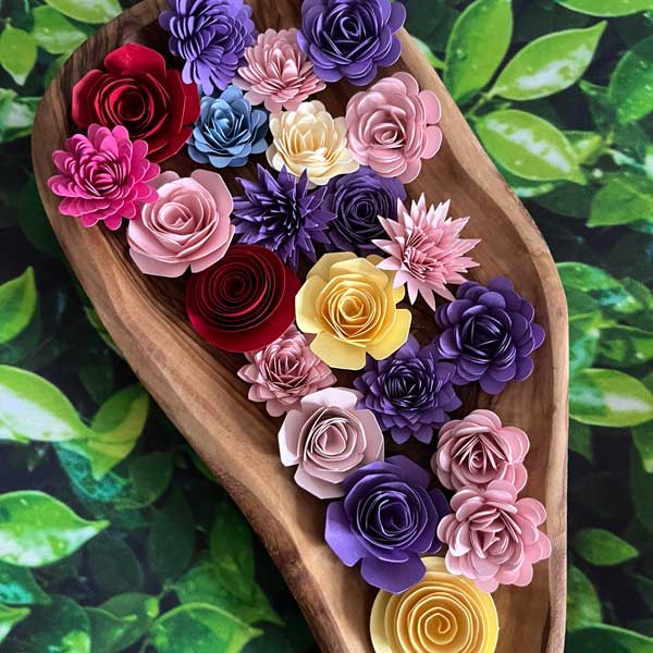 hand-rolled flowers in oblong shaped wooden bowl