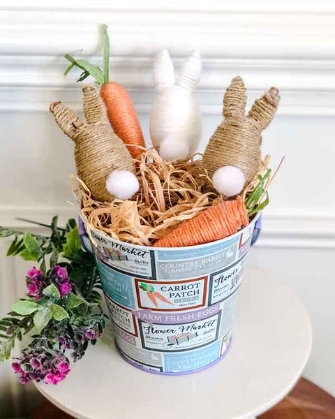 Craft image of Easter rabbits sitting in an Easter themed pale