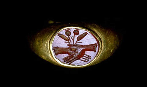 A gold betrothal ring of ancient Rome depicting the image of clasped hands