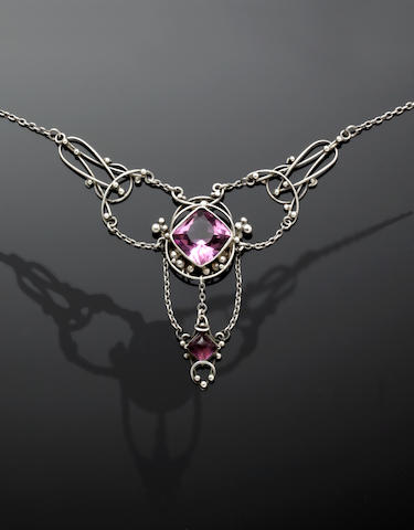 A necklace from the late Arts and Crafts movement featuring layered, open filigree and purple glass; Image: Bonhams