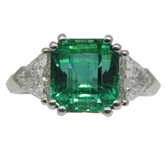 4.11ct. Emerald Three Stone Ring set Two Trillion Diamonds set in Platinum custom designed and manufactured by David Saad of Skyjems.ca