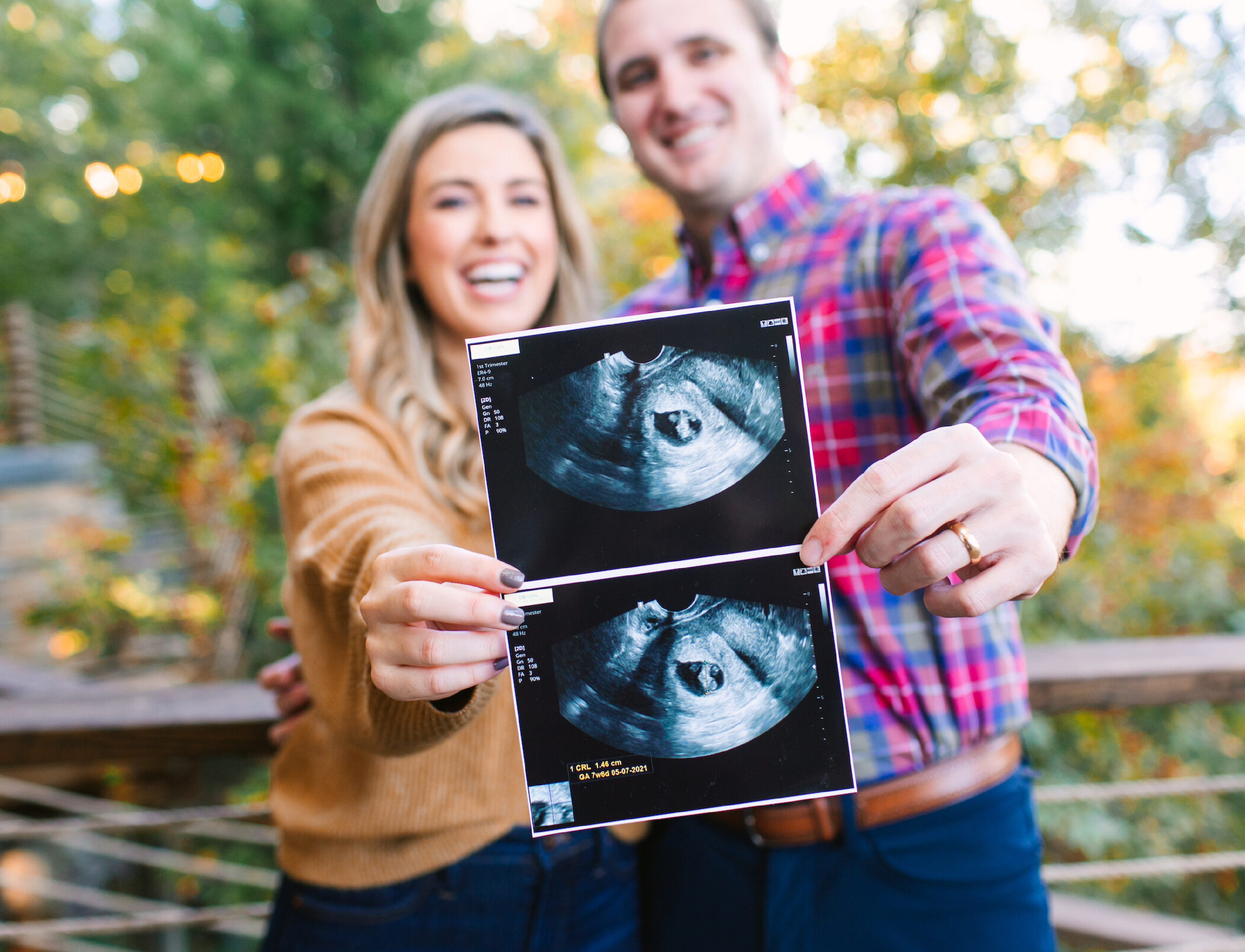 Happy couple holds up ultrasound picture