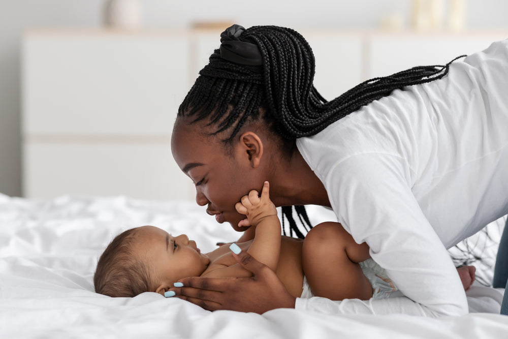 Mom with baby on bed