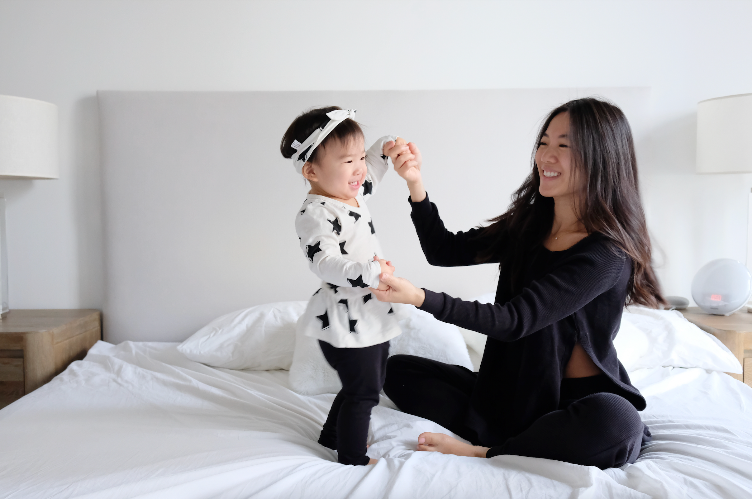 Mom and Toddler Playing on Bed