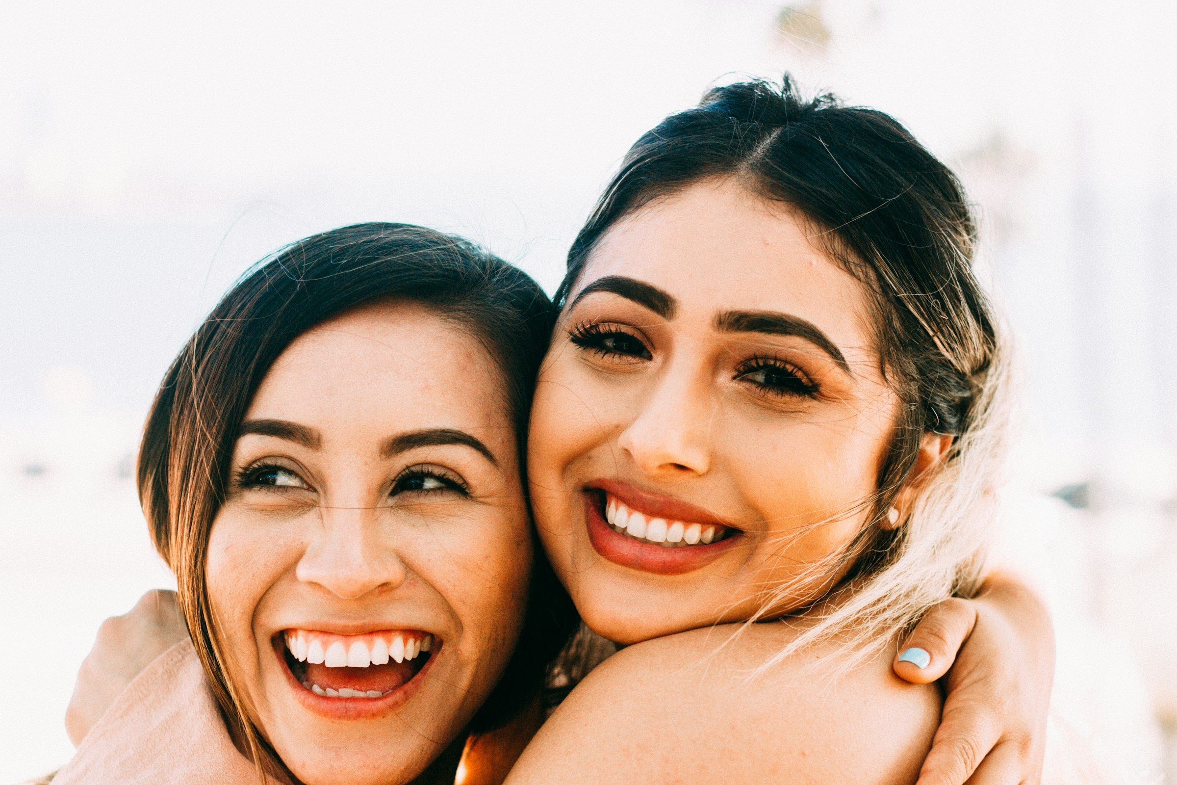 Two happy women embracing in a hug