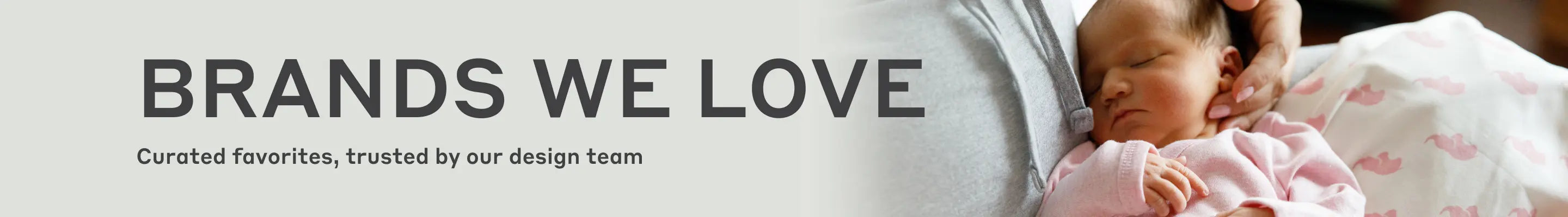 Banner with text 'BRANDS WE LOVE' and subtext 'Curated favorites, trusted by our design team', showing a close-up of a baby in pink pajamas being held by an adult.