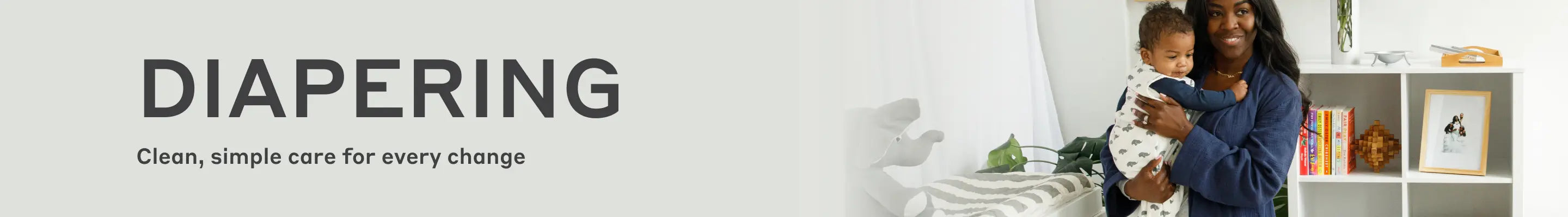 Banner with text 'DIAPERING' and 'Clean, simple care for every change', showing a smiling woman holding a baby in a nursery setting.