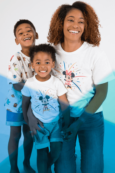 Mom and two boys in Disney 100 print clothing