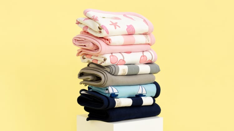 Stack of folded blankets in various colors