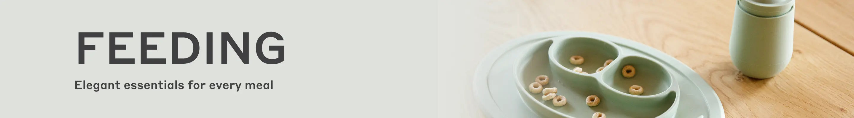 Banner with text 'FEEDING' and 'Elegant essentials for every meal', showing a divided plate with cereal and a cup on a wooden table.
