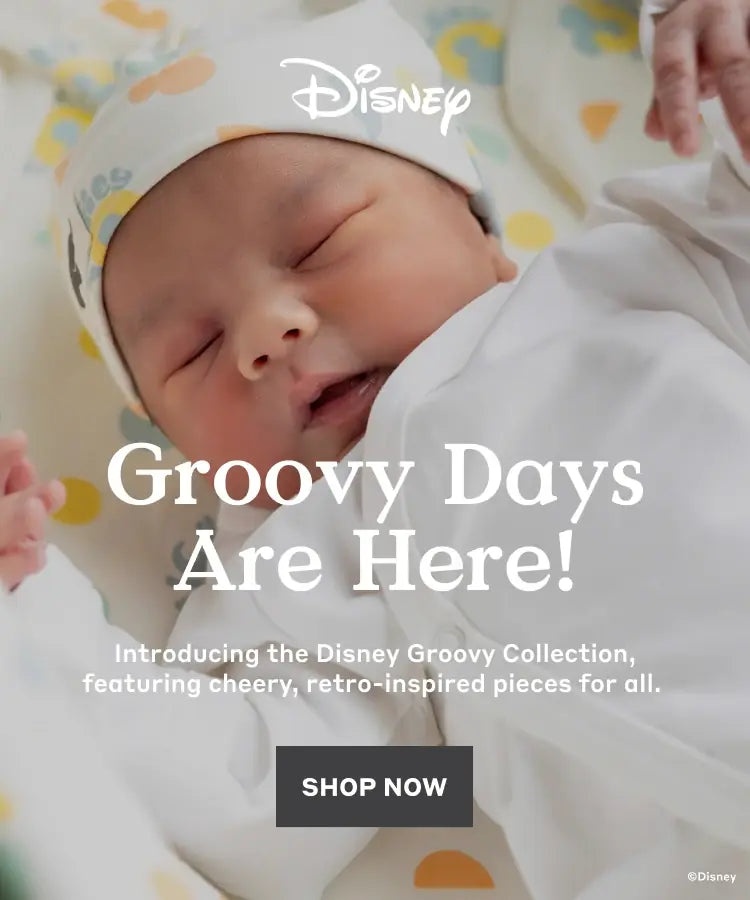 Hero banner with newborn in Disney Groovy print clothing and text: Groovy Days Are Here! Introducing the Disney Groovy Collection, featuring cheery, retro-inspired pieces for all - Shop Now