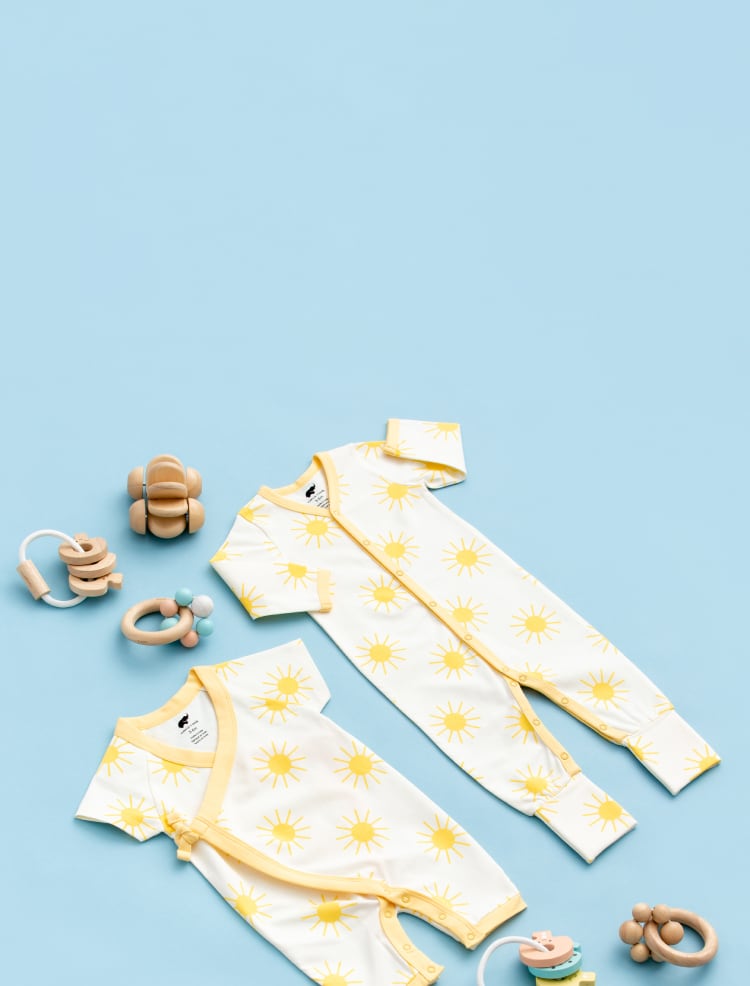 Flatlay of Suns Out print clothing on yellow background