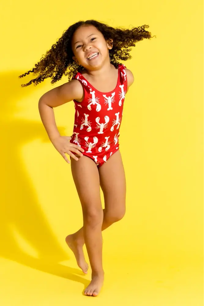 Girls lobster print swimsuit against yellow background