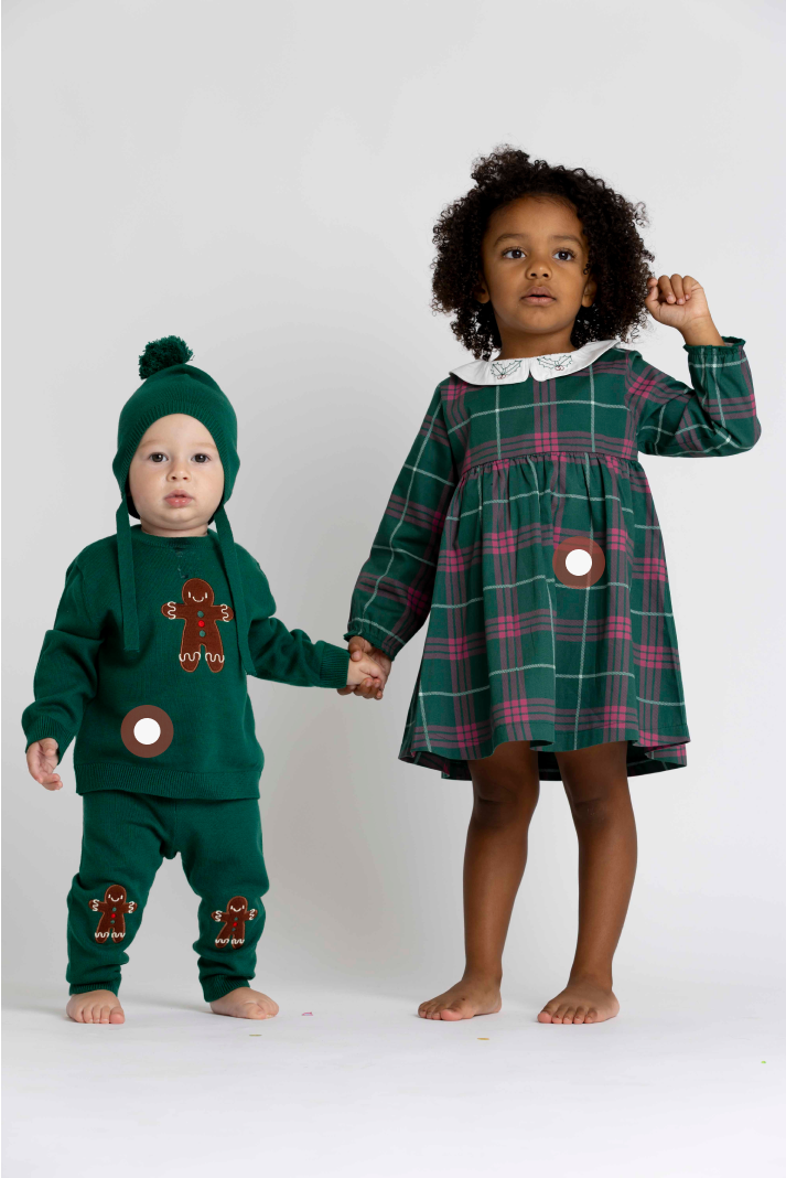 Mother and child wearing personalized matching sweaters with embroidered names