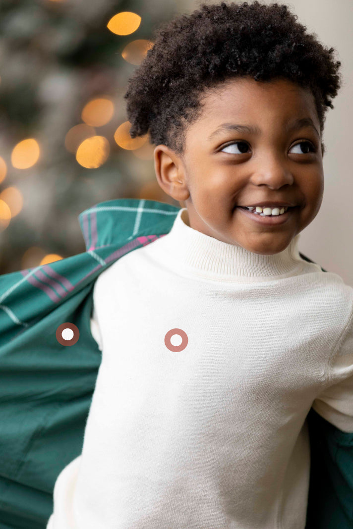 Mother and child wearing personalized matching sweaters with embroidered names