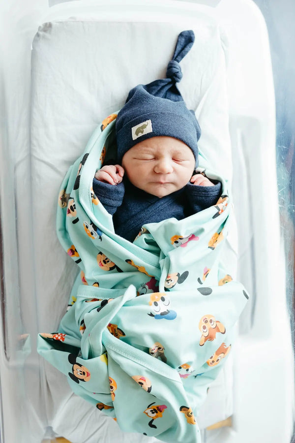 Newborn in Disney Pixar blanket and Top Knot Cap in navy blue