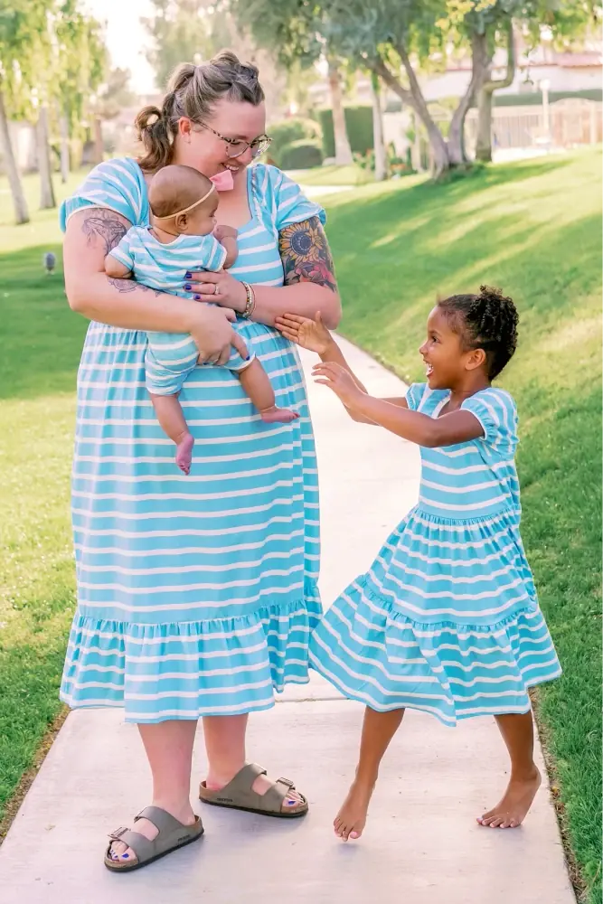 Family in matching blue stripe outfits