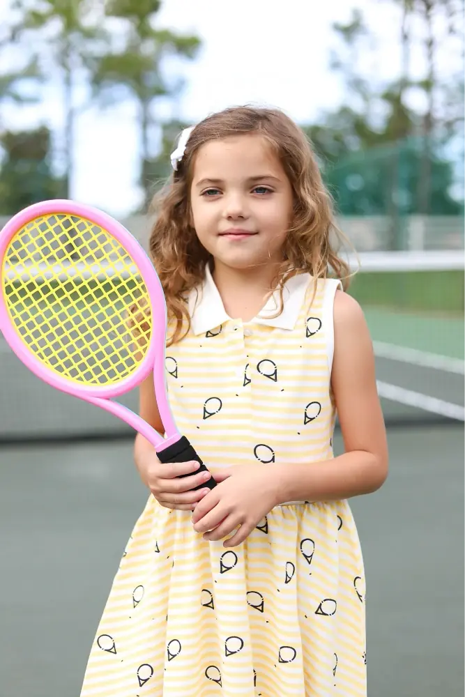 Young girl in Match Point print tennis dress