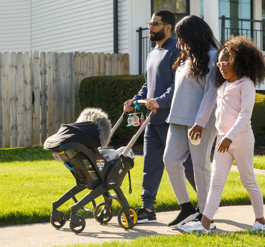 Family walking baby in stroller