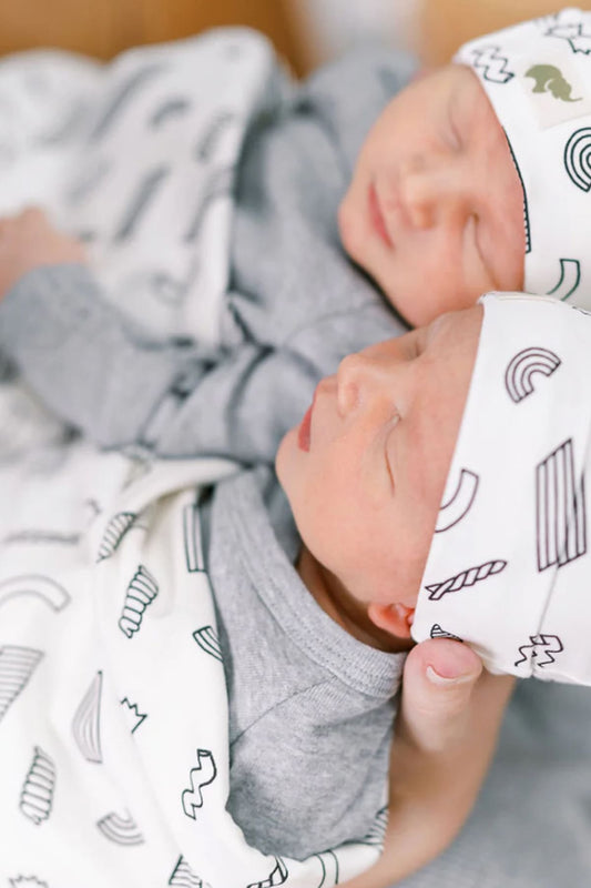 Newborn twins in a crib