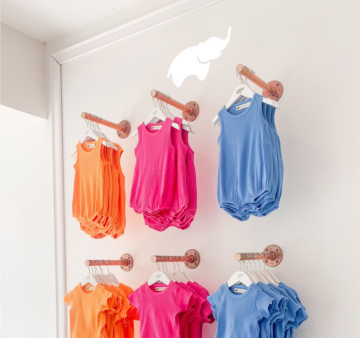 Guideshop wall with bright ribbed rompers