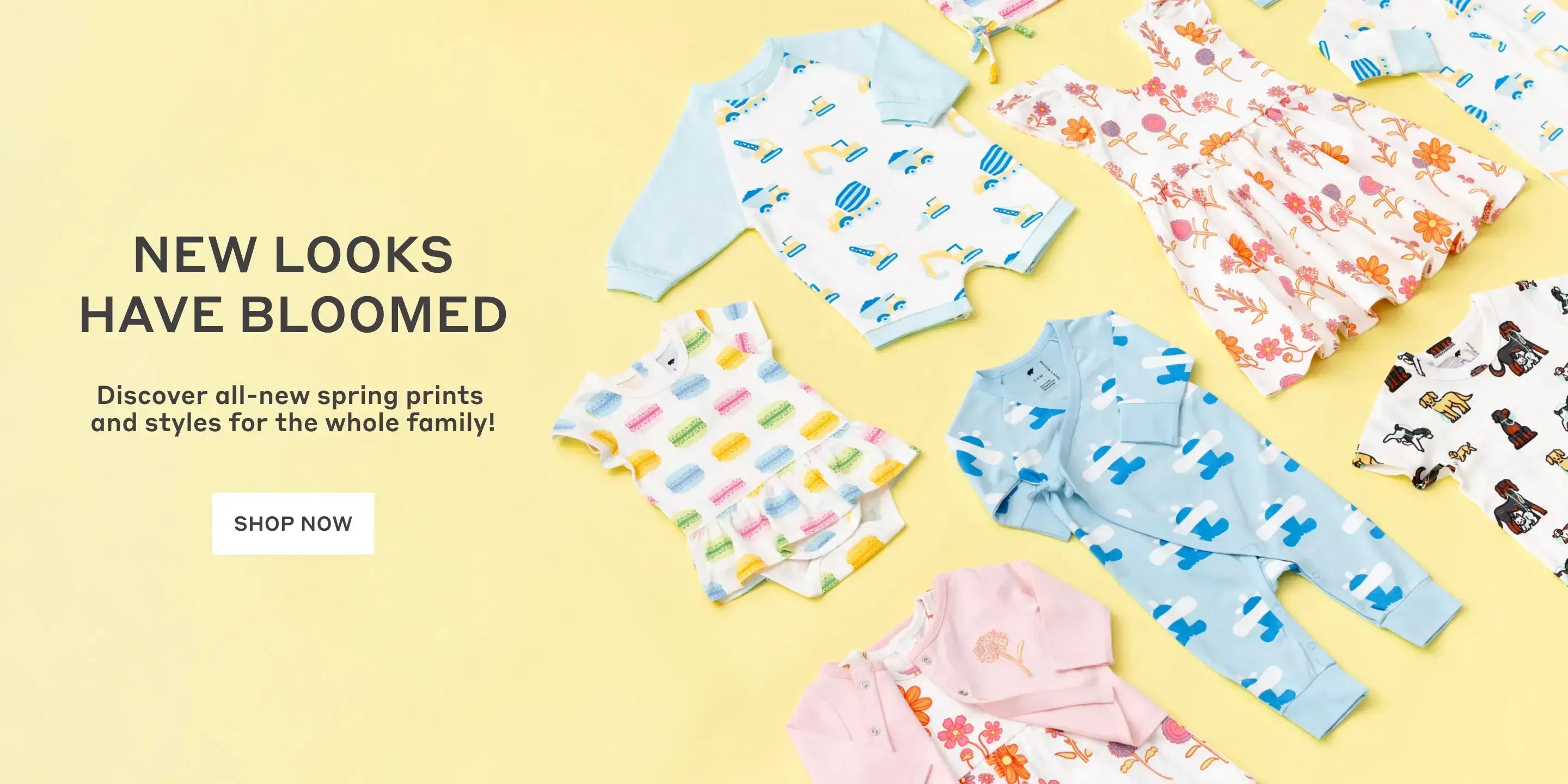 Hero banner with flatlay of spring print clothing with text: New Looks Have Bloomed. Discover all-new spring prints and styles for the whole family! - Shop Now