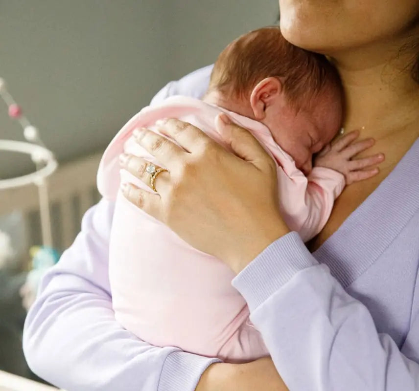 Mother holding newborn to her chest