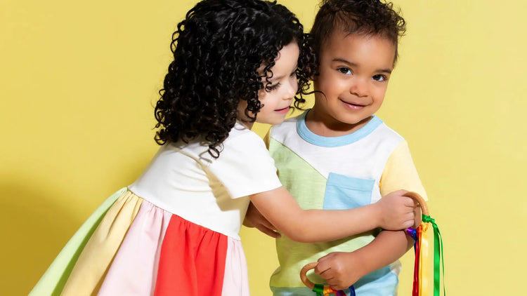 Two toddlers in matching spring print outfits