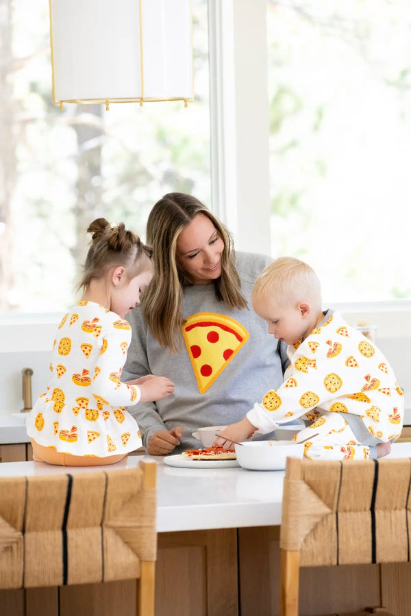 Mother and two toddlers wearing pizza print clothing