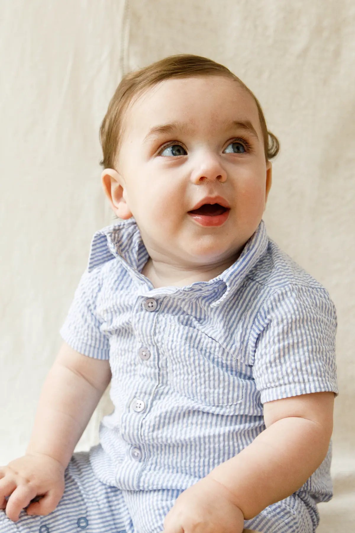 Baby in seersucker romper