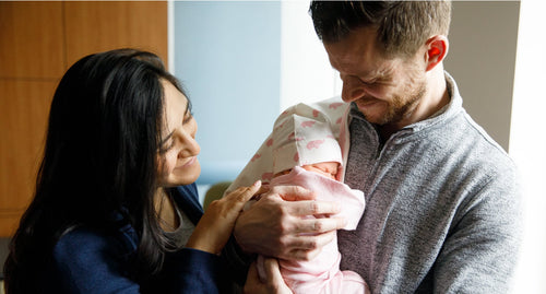 Couple holding newborn