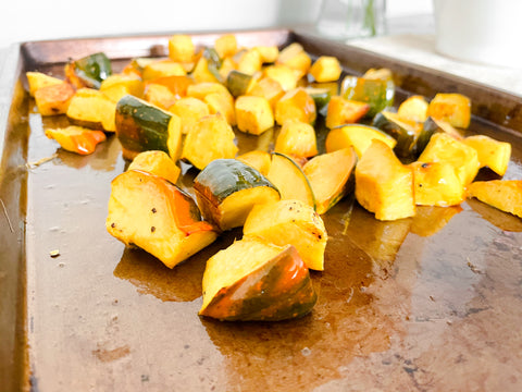 Cut up acorn squash on metal tray