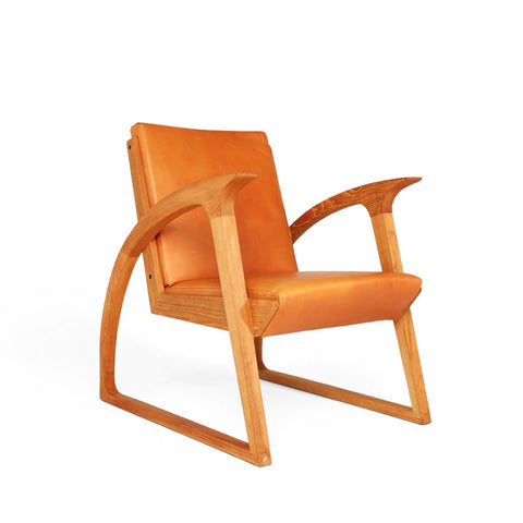 Havana Warm Orange hued Leather covered Jengki Chair which is a lounge chair designed by  Singgih S. Kartono from Indonesia