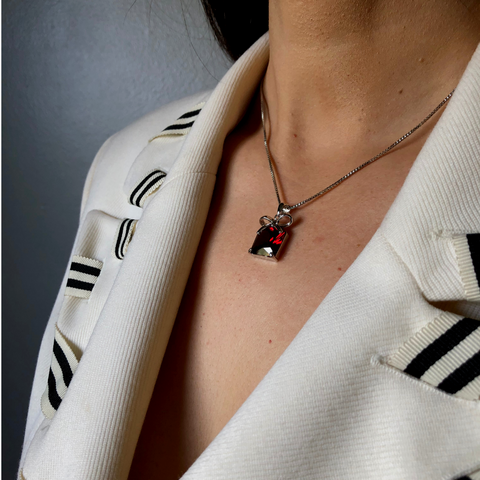 <img src="Red Crystal Necklace.png" alt="Red crystal necklace with a silver bow and silver plated chain. Length: 17.71 inches">