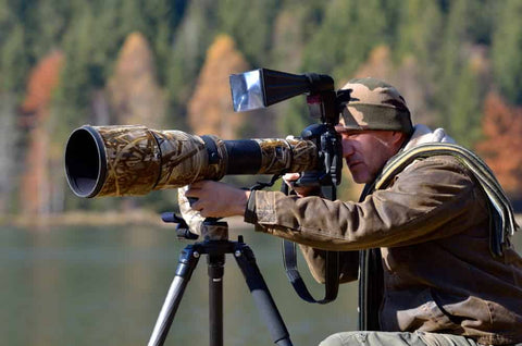 wildlife photography photographer with telephoto lens