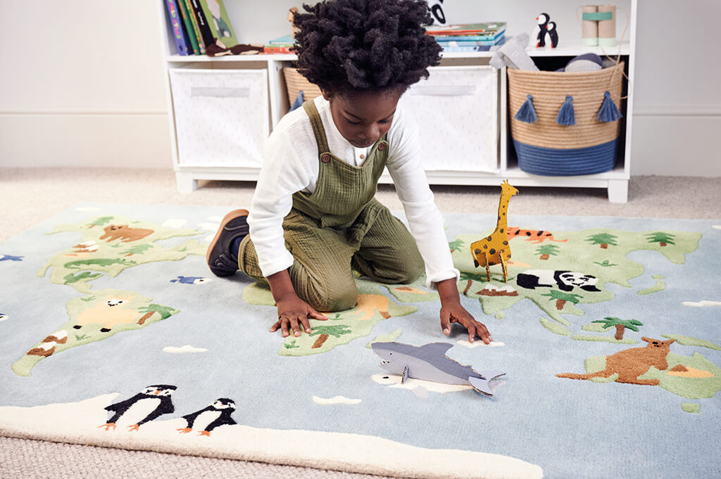 child playing on around the world rug